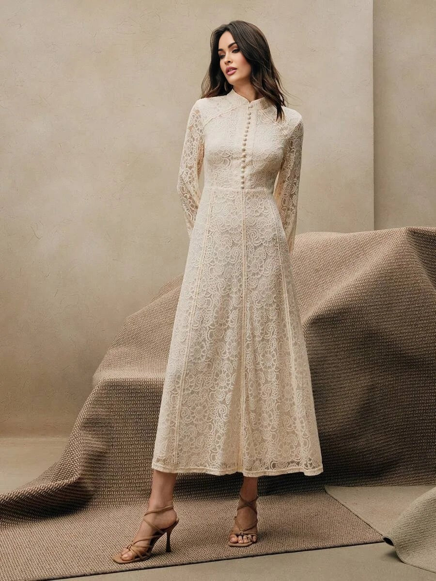 This elegant cream lace dress features a sophisticated high neckline and long sleeves, creating a timeless silhouette that's.