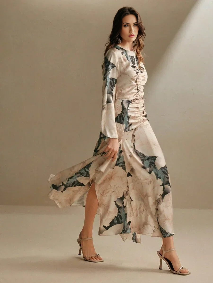 A sophisticated long-sleeve dress featuring a delicate floral print in soft beige and muted greens, designed with a.