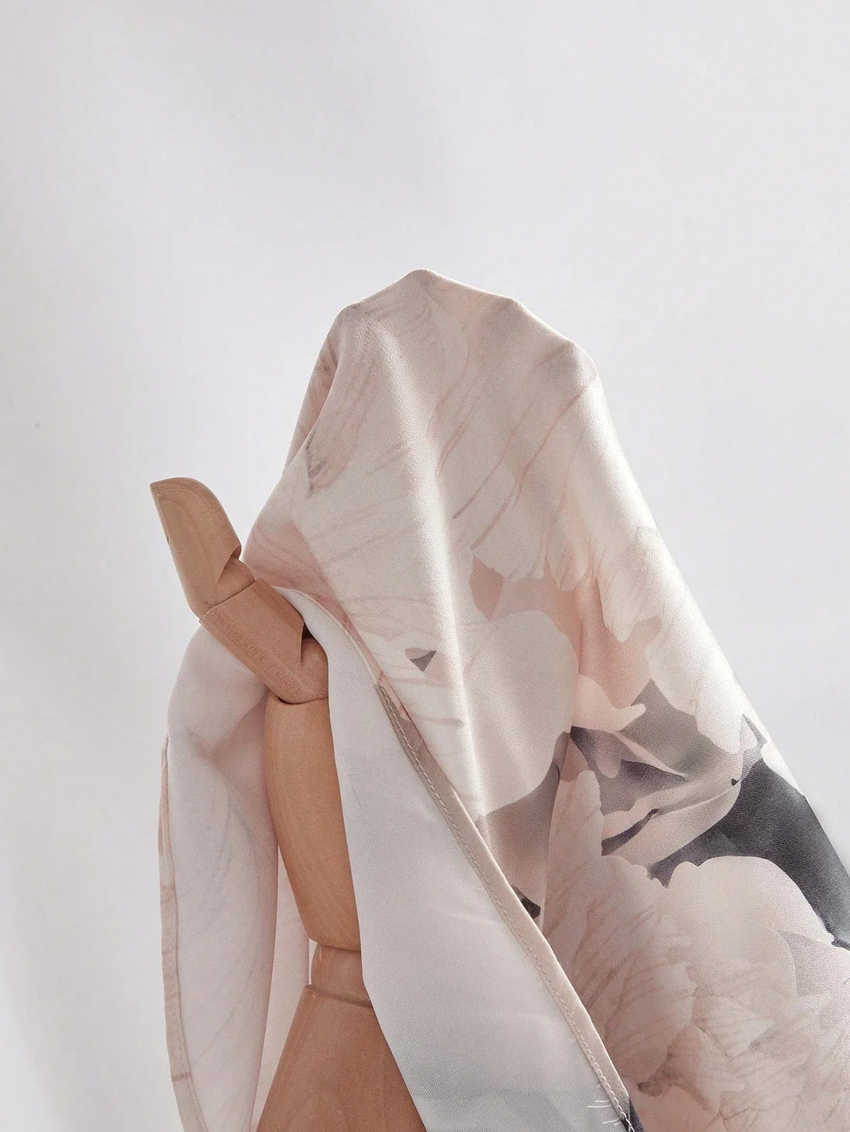 A delicate, flowing dress crafted from light, floral-printed fabric in soft pastels, featuring a relaxed fit that perfectly.