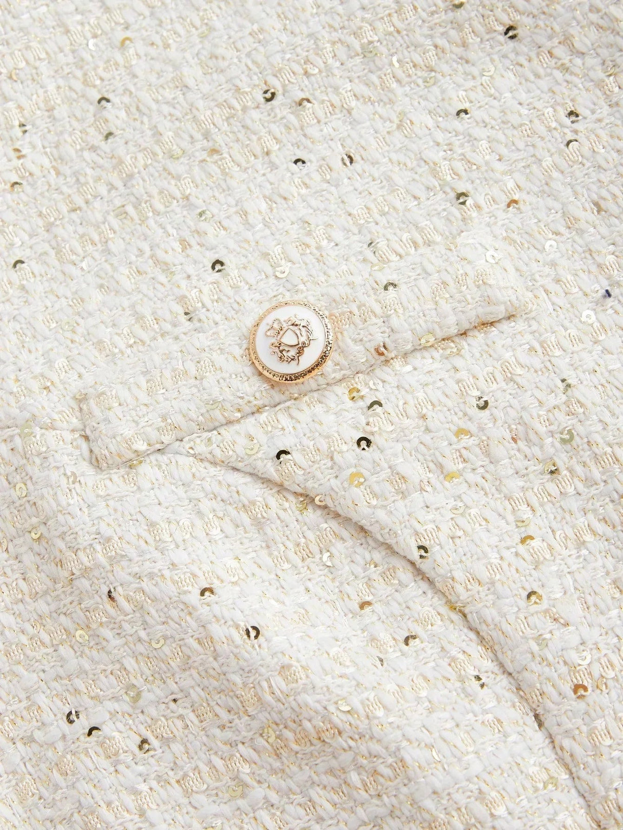 This elegant dress features a soft ivory hue with a textured, metallic woven fabric, adding a touch of shimmer. Designed for.