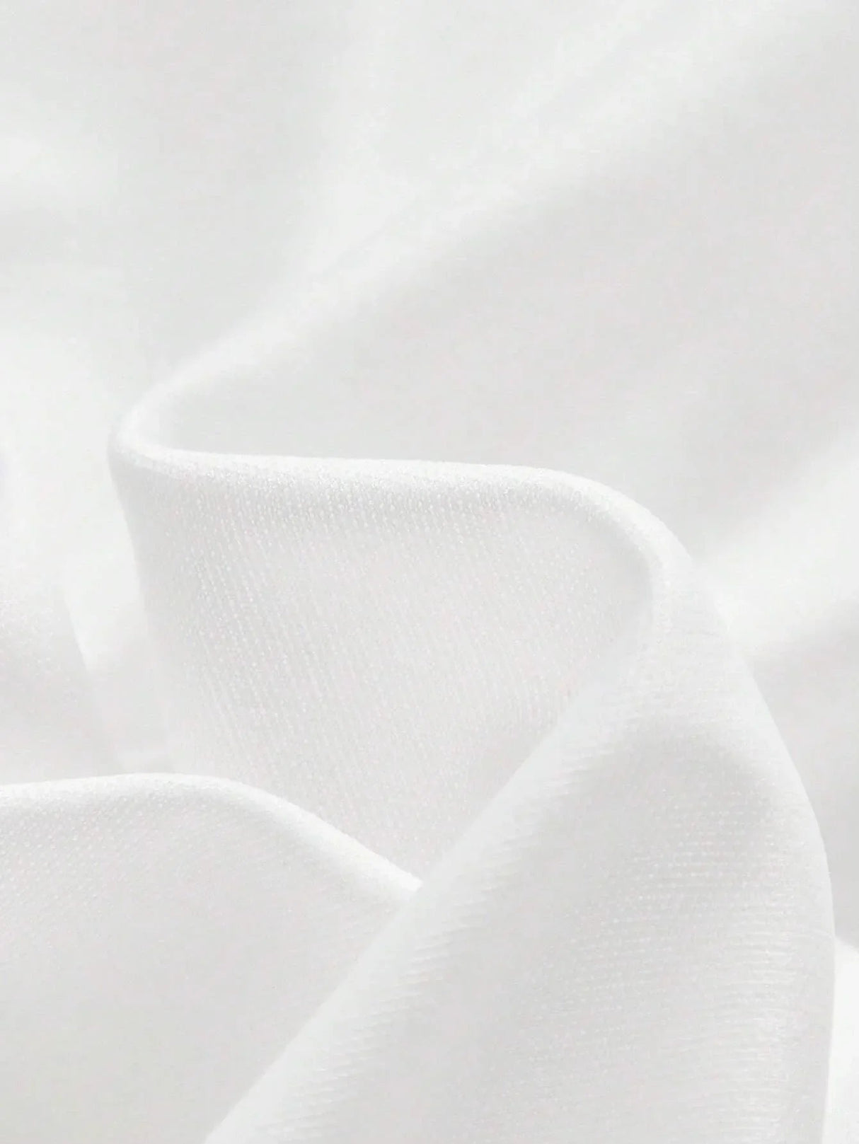 Luxurious and flowing, this elegant white dress is crafted from soft fabric that drapes beautifully, creating a flattering.