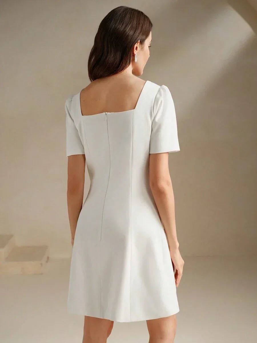 This elegant white dress features a stylish square neckline and short puff sleeves, creating a flattering fit that.