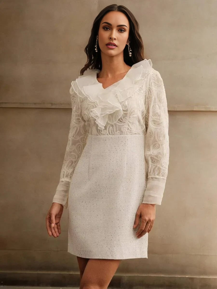 This elegant white dress features a fitted silhouette with delicate ruffled detailing around the neckline and long sheer.