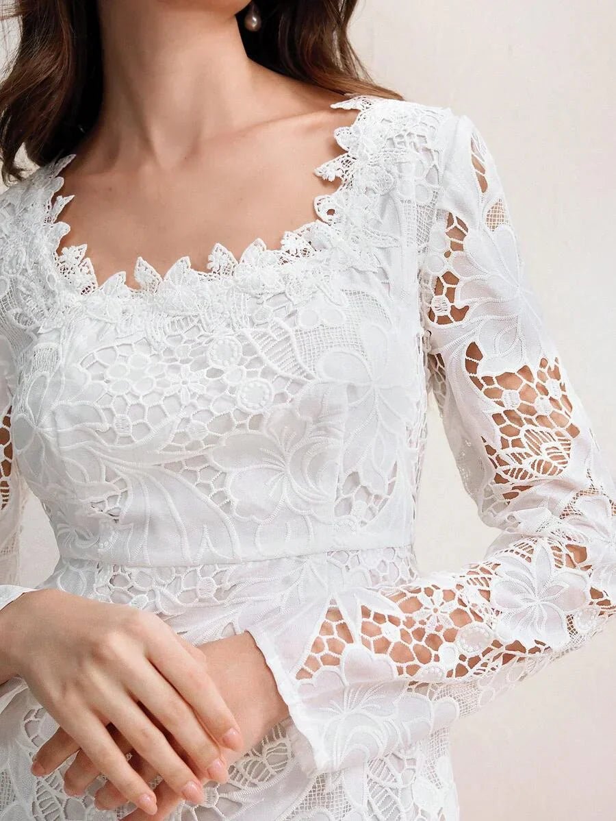 This elegant white dress features intricate floral lace detailing with a scalloped neckline and bell sleeves, exuding a.