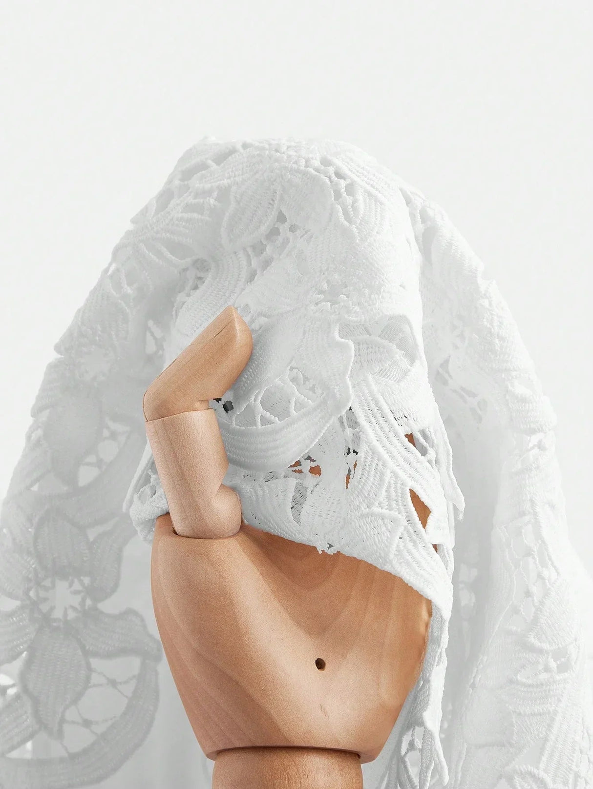 Stylish and ethereal, this exquisite white lace dress features intricate floral patterns that beautifully drape over the.