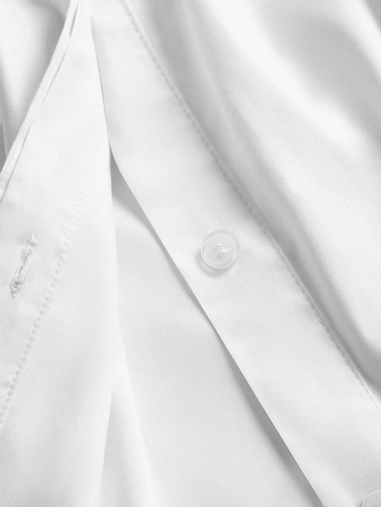 This elegant white dress features a sleek button-up design, showcasing a refined and polished look perfect for various.
