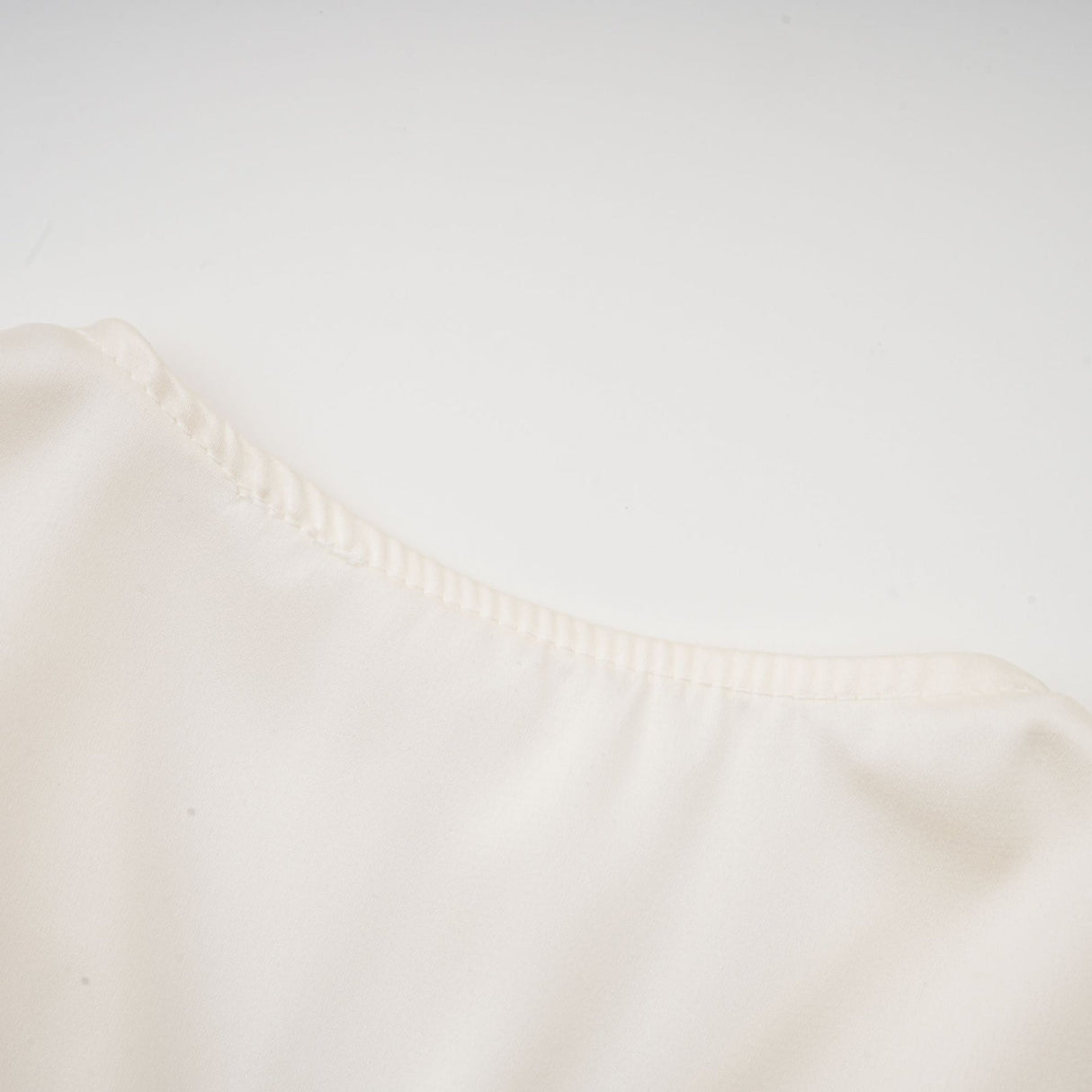 Nouria White Satin Cropped Blouse With Twist Front and Smocked Hem