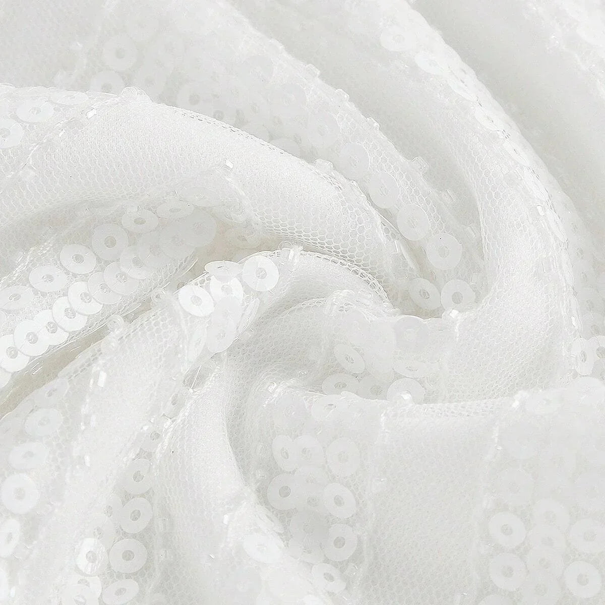 This elegant white dress showcases a shimmering sequined fabric that catches the light beautifully, creating a stunning.