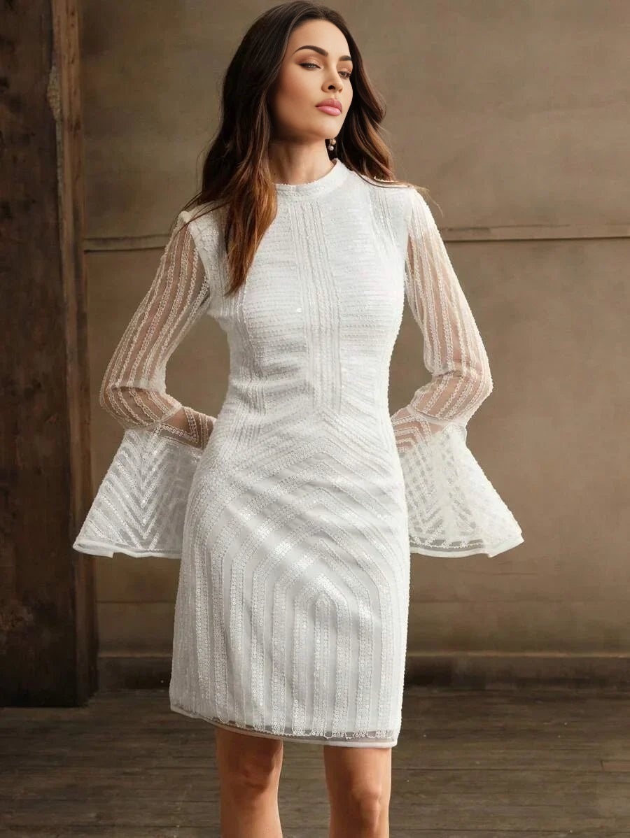 This elegant white dress features intricate detailing with a fitted bodice and striking bell sleeves that add a touch of.