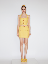 Sophia embellished tweed mini skirt in vibrant yellow with a high-waisted fit, crystal embellishments, gemstone belt, and front pocket details, crafted from 100% polyester.