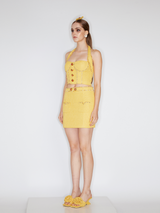 Sophia embellished tweed mini skirt in vibrant yellow with a high-waisted fit, crystal embellishments, gemstone belt, and front pocket details, crafted from 100% polyester.