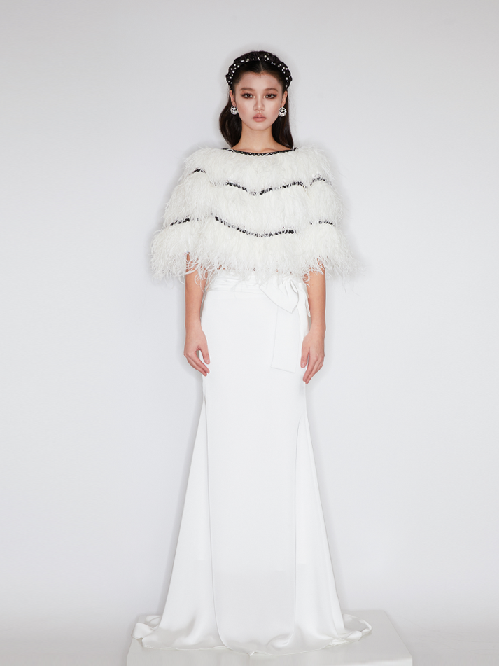 Sophia asymmetric white evening dress with a delicate bow detail, flowing silhouette, and layered hemline, crafted from lightweight polyester.