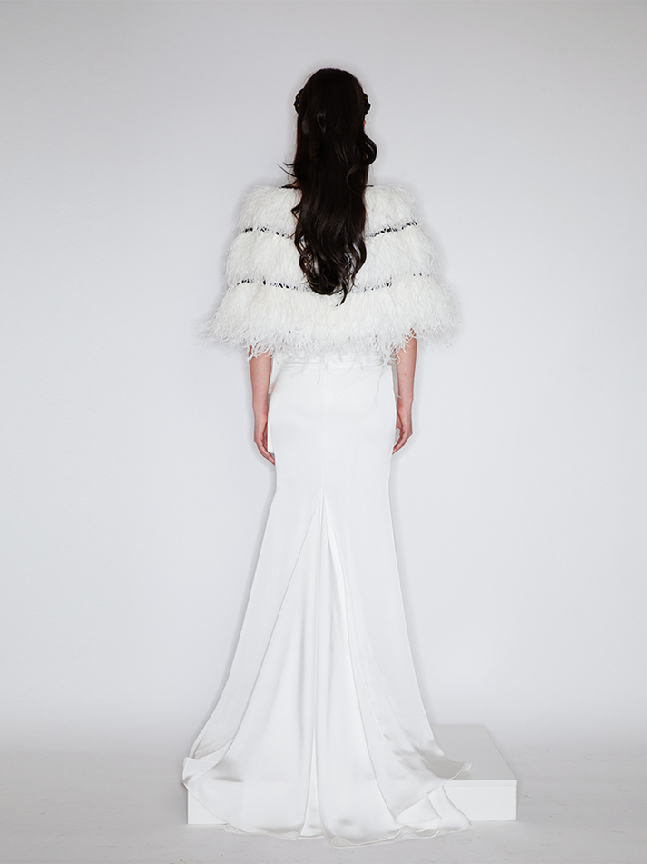 Sophia asymmetric white evening dress with a delicate bow detail, flowing silhouette, and layered hemline, crafted from lightweight polyester.