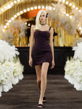 Fitted mini dress with shimmering embellishments, delicate straps, and a structured silhouette. Made from 85% polyester, 15% wool, and lined with 100% polyester