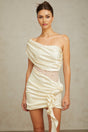 A beige asymmetric mini dress with delicate lace panels featuring a sleeveless design and a flowy skirt