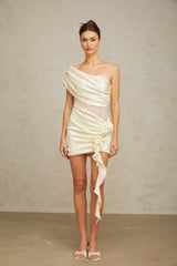 A beige asymmetric mini dress with lace panels and a neutral color scheme