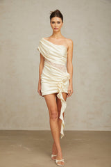 A beige asymmetric mini dress with lace panels and a sleeveless design featuring a flowing skirt and delicate neutral tones