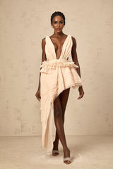 A beige asymmetric mini dress with ribbon design details and a flattering silhouette featuring neutral tones