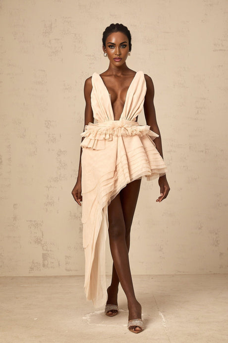 A beige asymmetric mini dress with ribbon design details and a flattering silhouette featuring neutral tones