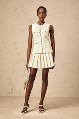 A beige knit vest top and matching skirt set adorned with sequins named Helene The top is sleeveless and the skirt is knee length Both pieces feature a shimmering sequin pattern throughout