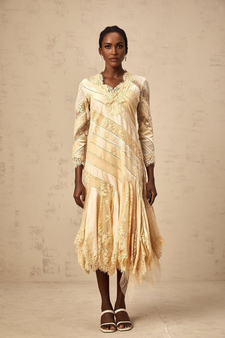 A beige midi dress with diagonal stripes and panel details named Ingrid