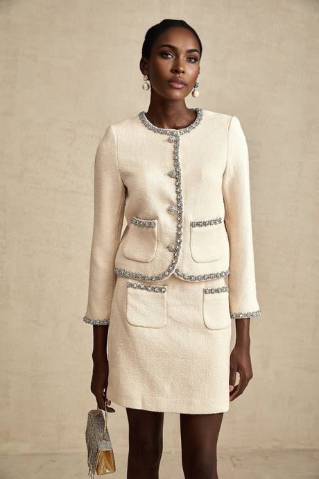 A beige tweed cardigan and matching skirt set with crystal embellishments named Elisabeth featuring a classic and elegant design