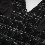 A black and white checked tweed matching set featuring a sleeveless vest top and skirt in a classic pattern