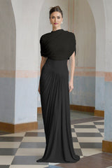 A black asymmetric maxi dress with pleated details named Catherine featuring a long flowing skirt and uneven hemline