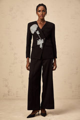 A black blazer adorned with floral embellishments featuring a flower motif design named Therese