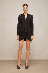 A black blazer dress with sequin embellishments featuring a tailored silhouette and sparkling details throughout