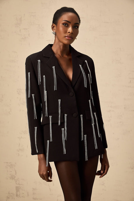 A black blazer with crystal tassels adorning the garment providing a sparkly and glamorous accent to the classic silhouette