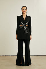 A black blazer with cutout details and a decorative bowknot featuring a sleek design and tailored silhouette