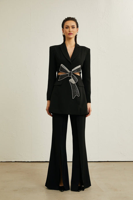 A black blazer with cutout details and a decorative bowknot featuring a sleek design and tailored silhouette