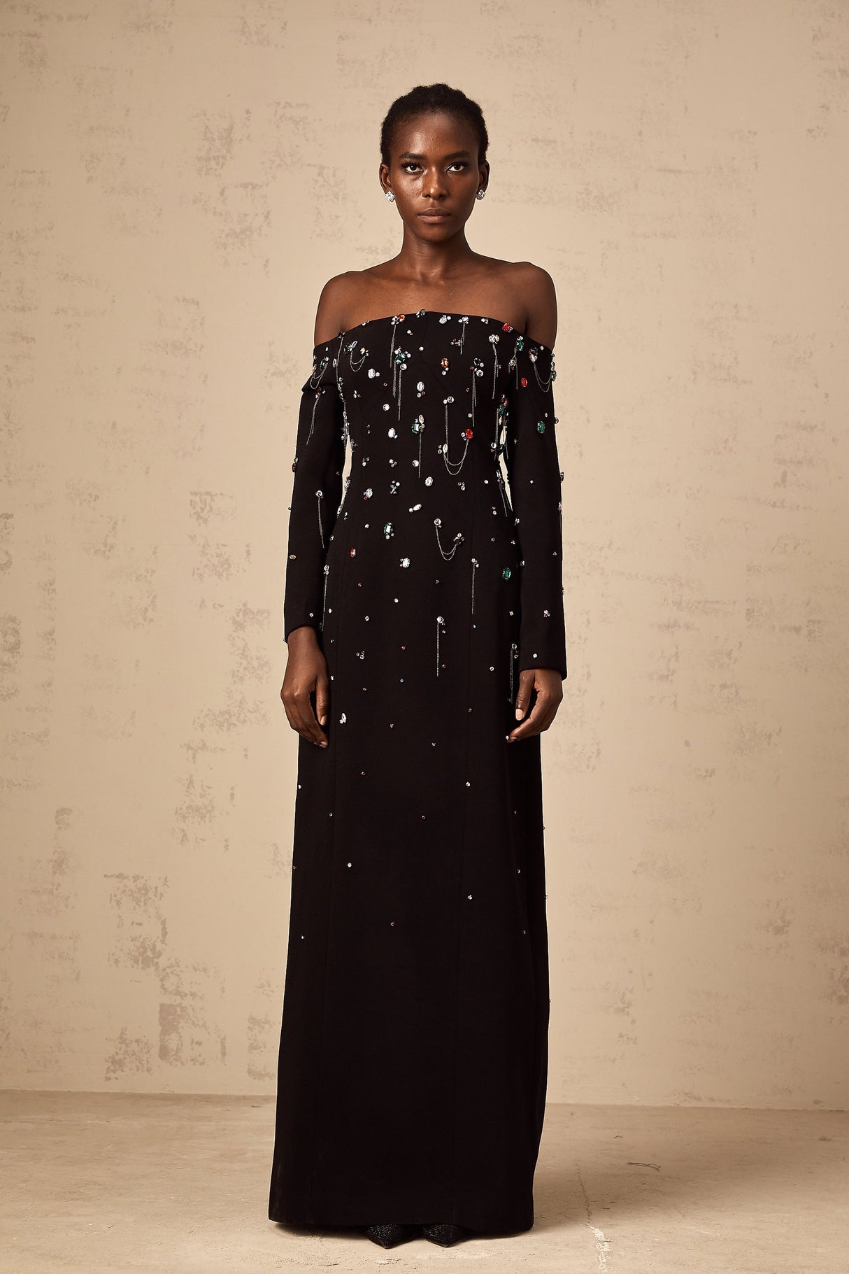 A black crystal embellished offshoulder maxi dress with a flowing silhouette named Gabrielle