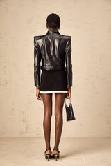 A black doublebreasted jacket made of faux leather named Diane worn by a model