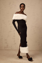 A black faux fur off shoulder midi dress worn by a model standing against a plain background
