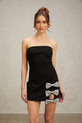 A black fitted mini dress with studded details and a bowknot accent
