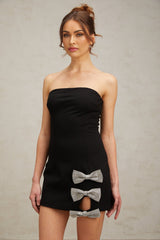 A black fitted mini dress with studded details and a bowknot accent