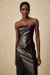 A black floor length dress with a faux leather bodice and lace panels along the sides and sleeves