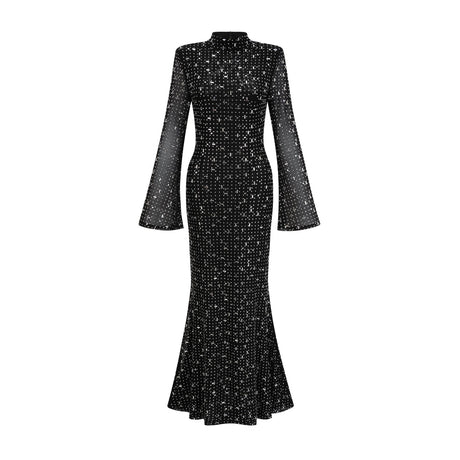 A black floor length maxi dress with sheer elements and embellishments worn by a female model