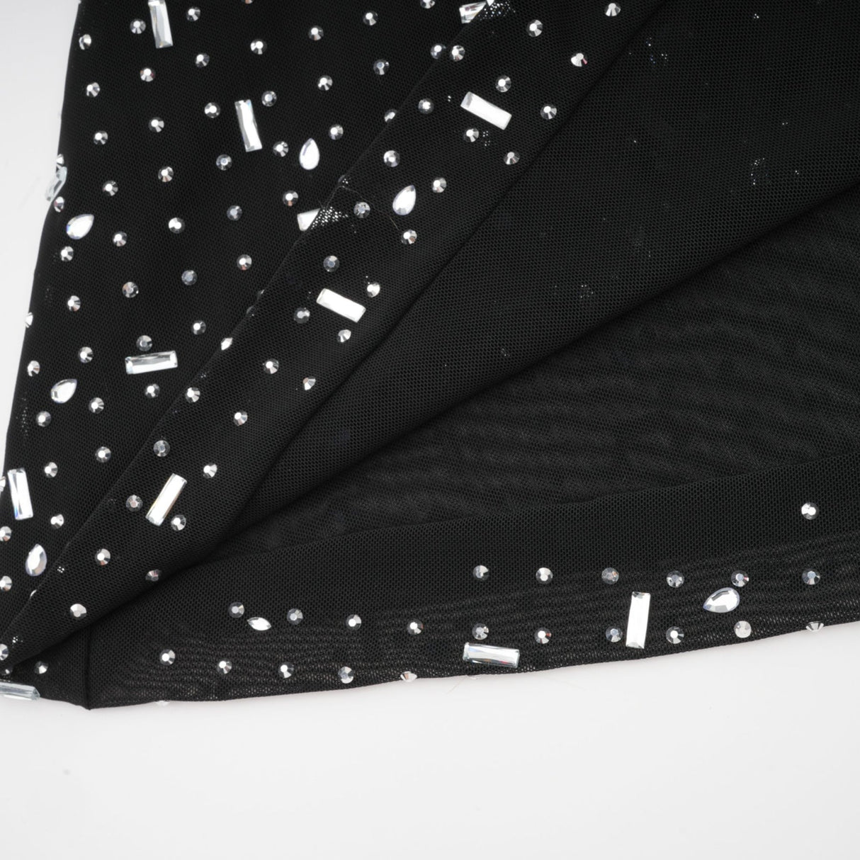 A black floor length maxi dress with sheer fabric and embellished details worn by a model