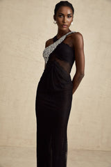 A black floorlength maxi dress with a crossover bodice featuring crystal embellishments and a flowing skirt