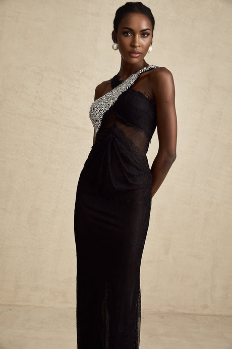 A black floorlength maxi dress with a crossover bodice featuring crystal embellishments and a flowing skirt