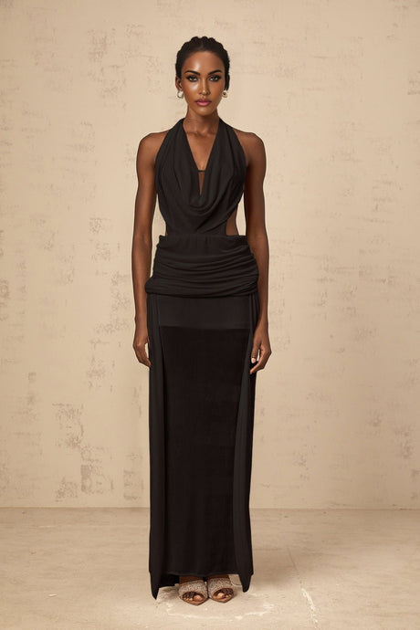 A black floorlength maxi dress with a halter neckline and open back design worn by a model