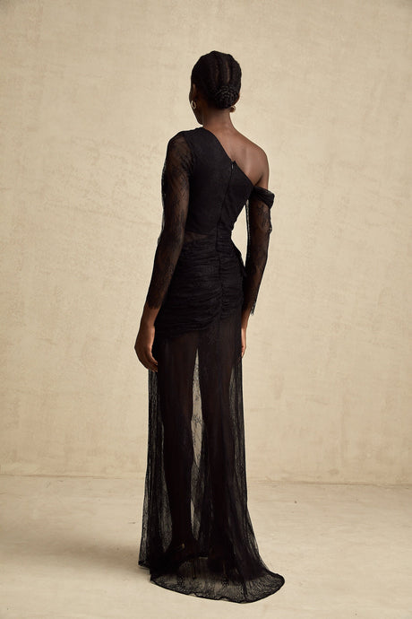 A black floorlength maxi dress with a single shoulder strap and a cut out detail