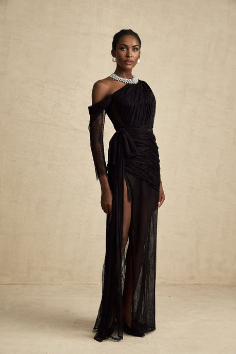 A black floorlength maxi dress with a single shoulder strap and a cutout detail featuring a sleek and elegant design