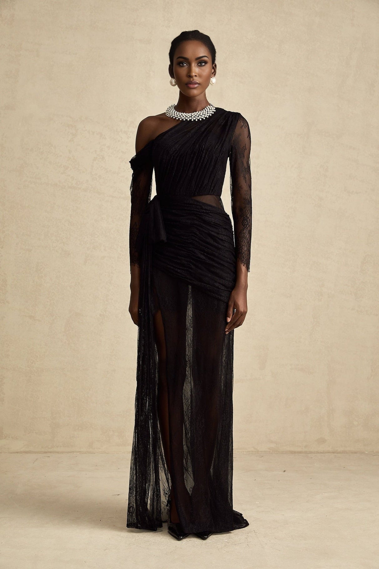 A black floorlength maxi dress with a single shoulder strap and a cutout detail on one side