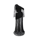 A black floorlength maxi dress with a single shoulder strap and a cutout detail worn by a model against a plain background