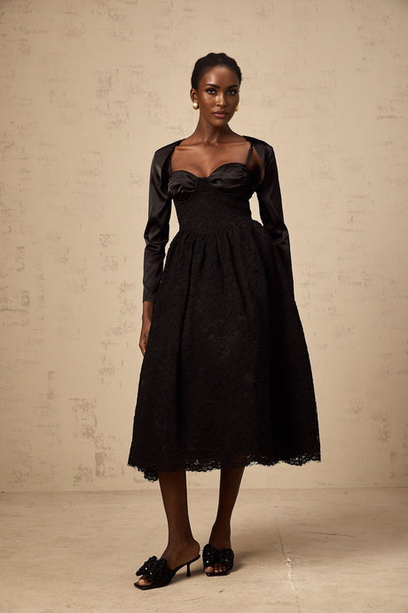 A black floral lace matching set consisting of a top and dress with delicate lace patterns and floral designs