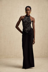A black floral lace maxi dress with halter neckline named Camille featuring a long flowing skirt and intricate lace pattern throughout
